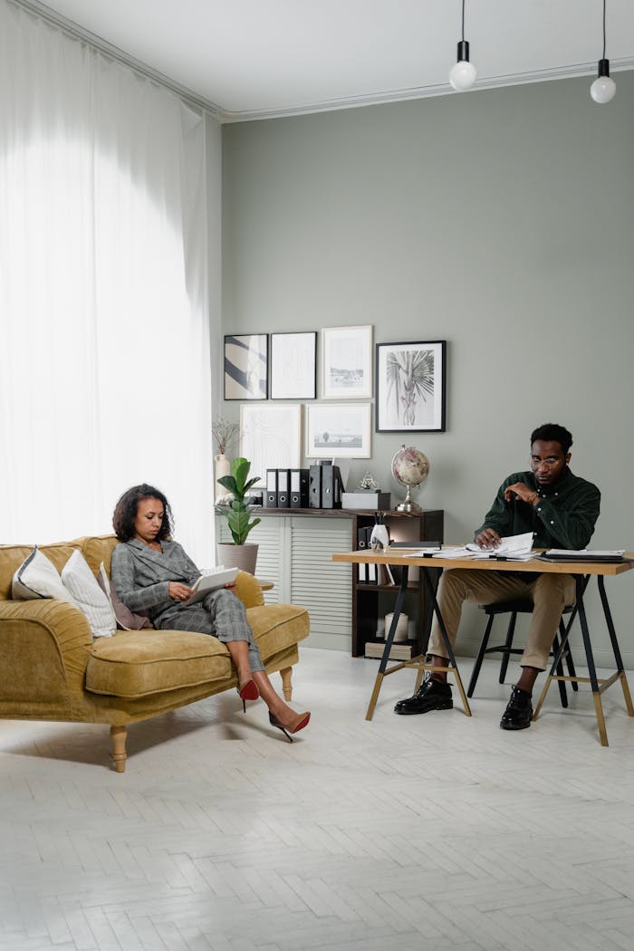 Elegant modern office space with a man and woman working together indoors, emphasizing finance and collaboration.